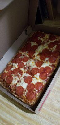 A delicious Sicilian pizza with pepperoni