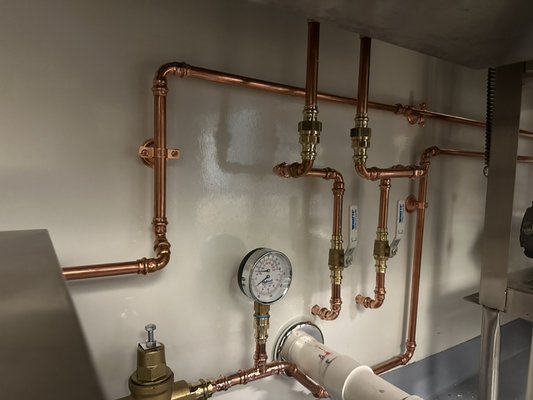 Piping for a hot water booster for a commercial dishwasher