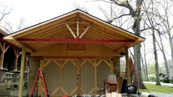 Built garage carport roof with barn style doors with hidden fasteners attic access T111 facade