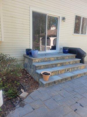 New concrete stoop with flagstone on top and fieldstone on the sides.