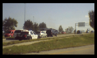 A HPD squad car races over the Calumet Avenue Xpressway bridge to attend to a car fire that was underneath it.