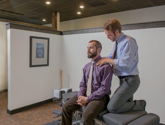 Simpsonville Chiropractor Dr. Kyle Price analyzing an athlete.