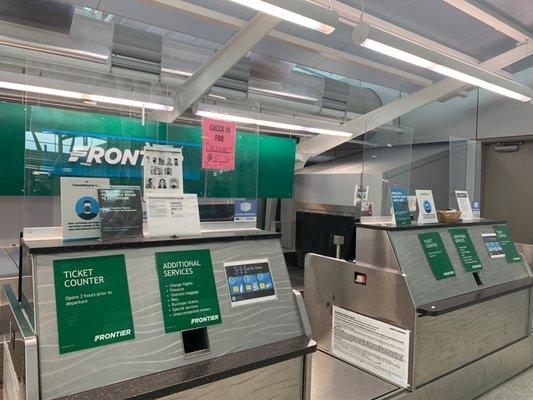 Empty check in area with a lame sign that shows the time for check in