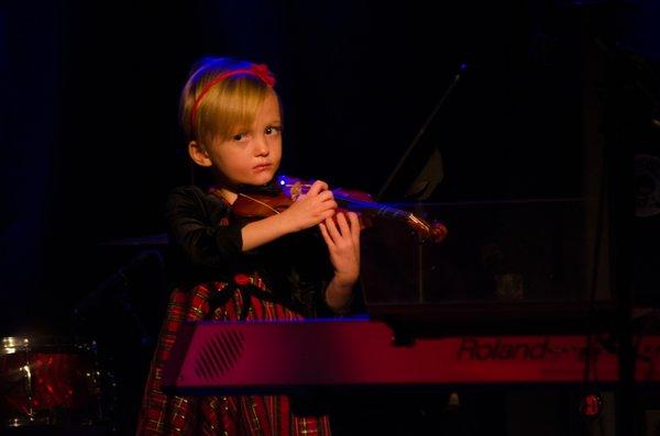 A young violin student performing at our Winter Recital