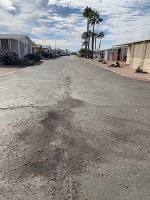 Streets are cracked asphalt, dirt, and rocks.