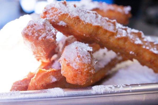 Tossed churros with powdered sugar