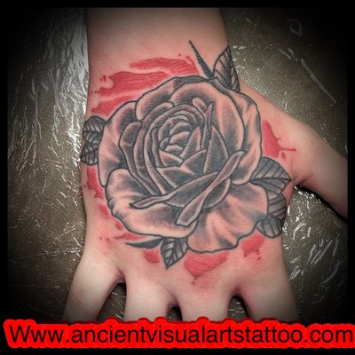 Black and grey rose on a hand done by josh