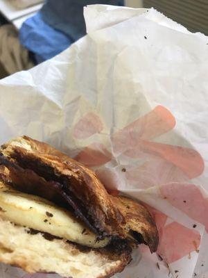 Dunkin' Donuts bacon egg and cheese croissant with black burned bacon and burned croissant that was served to me.