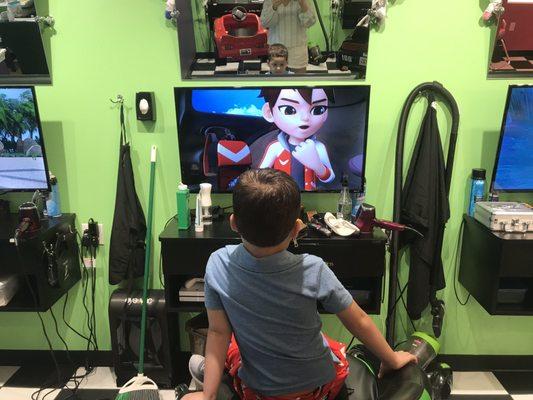 Jay Jay watching cartoons while he gets his haircut