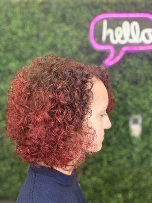 Textured curly haircut and brown to red color melt