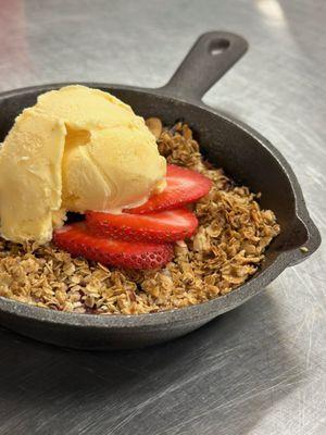 Indulge in our Seasonal Fruit Cobbler: fresh fruit, oat crisp, and rich vanilla ice cream - the essence of summer on your plate!