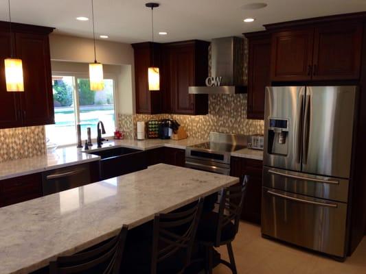 Transferred from an 80's kitchen with intrusive soffits and walls to this open space with a huge island