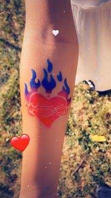 A flaming heart airbrush tattoo.