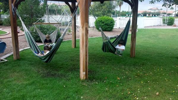 Relaxing outside while reading in the hammocks.