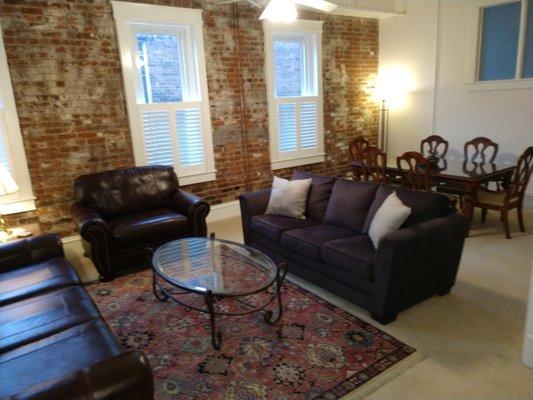 Living room with dining room table in the background.