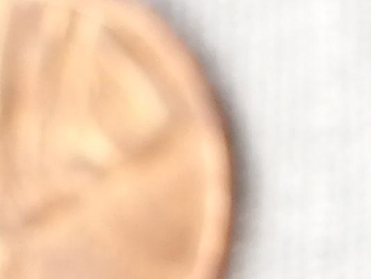 Image of barber dime on a penny upside down