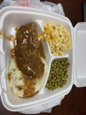 Lunch special hamburger steak with mashed potatoes, Mac and peas