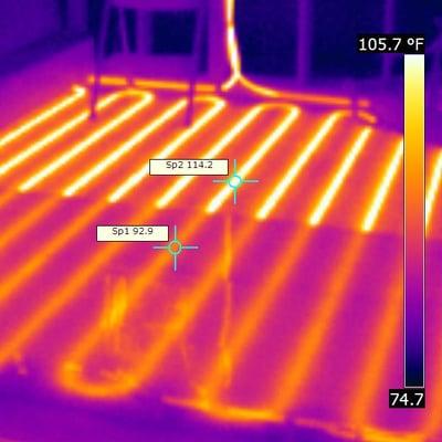 Infrared imaging of sub-surface radiant floor heating plumbing lines.