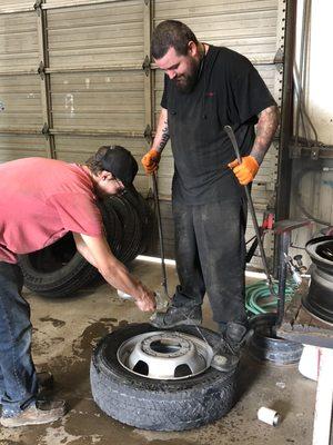 Matthew and Taylor breaking down a 19.5 truck tire.