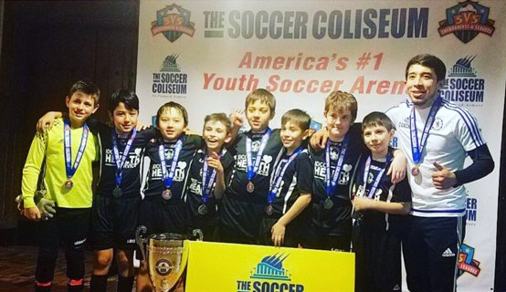 Taking home trophies at the Soccer Coliseum.