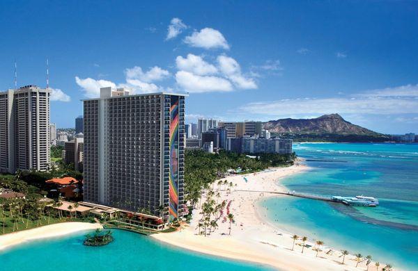 Hilton Hotel gleams in Waikiki, with the iconic Diamond Head silhouette gracing the horizon, fusing luxury with nature's majesty.