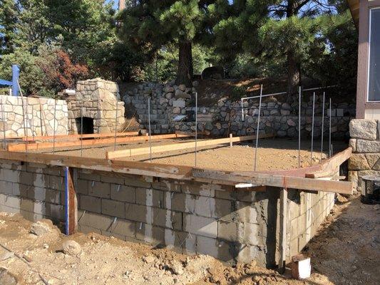 Spilt Face Granite Rock by Hand is a Beautiful Custom Design to any Retaining Wall.  - During Construction (Before)