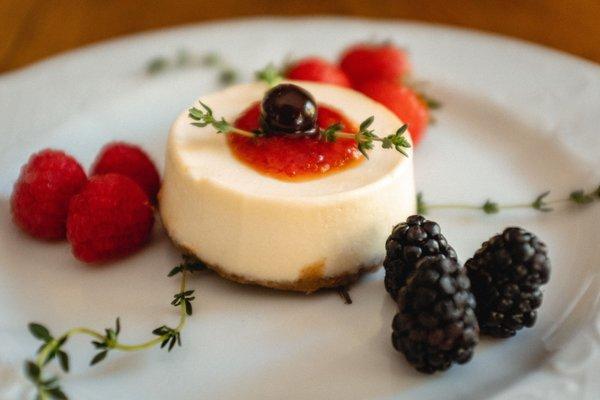 Ricotta and berry cheesecake topped with a Calabrian chili jam and garnished in thyme.