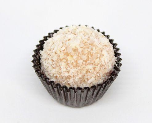 Coconut Brigadeiro with coconut flakes.