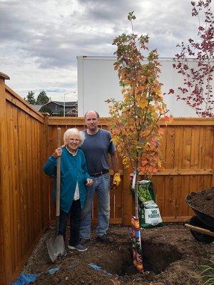 Mom and Marvin planting Gary's tree