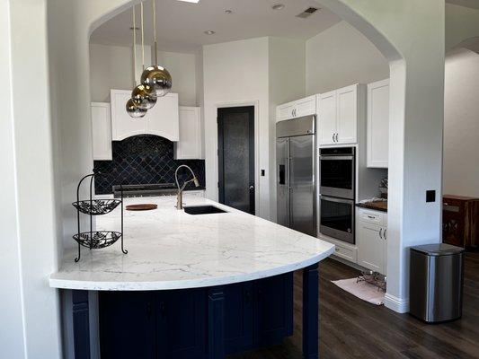 Kitchen remodel with new cabinets, blue island cabinets matching the backsplash tile