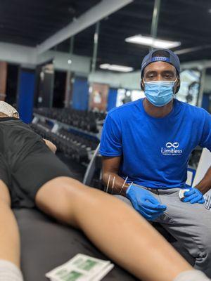 Seth, speaking with a client during a dry needling session