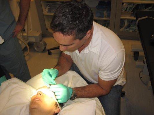 Dr. Wiesman performing an eyebrow transplant