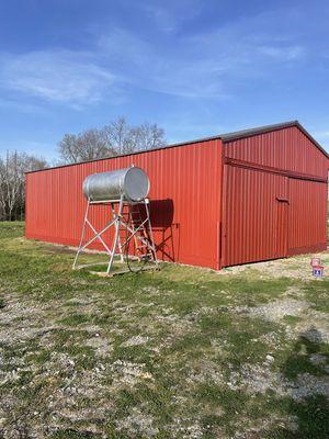 After picture of metal hog barn. Sherwin Williams pro-industrial A100 higgins red barn color.