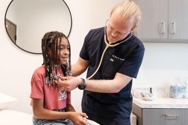 Dr. Travis Simmons examining a patient