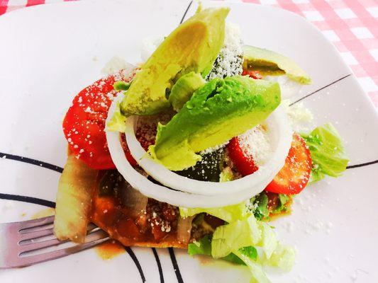 Pinto bean tostada with avocado, onions, tomato, peppers, cotija cheese, lettuce, sour cream! AMAZING