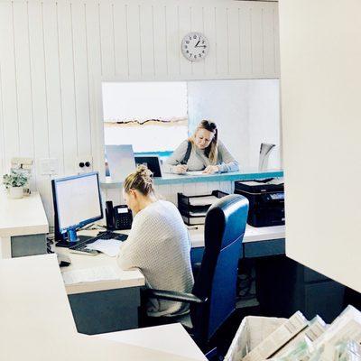 Office manager helping new patient with health history.