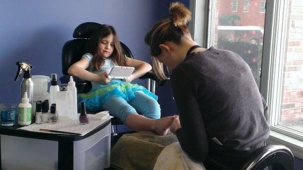 Stylist, Heather Dagesse, giving our younger client, Dani, a Birthday Pedicure.