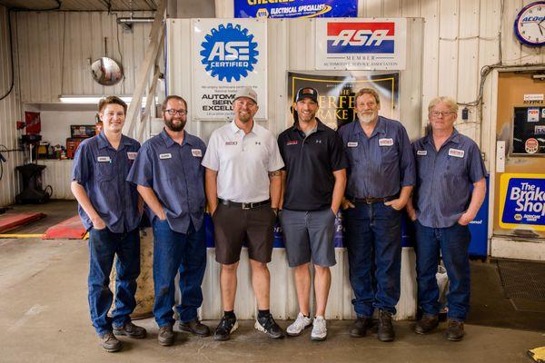 Here's a photo of our expert team inside the shop! Our ASE Certified technicians offer oil changes, brake work, tire services, and more!