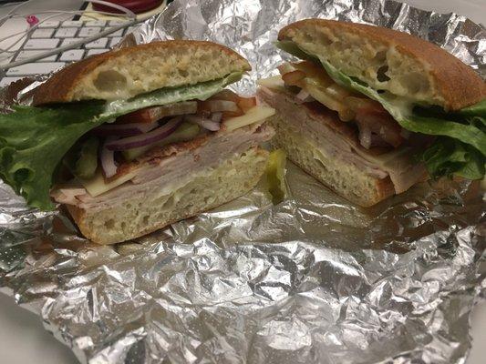 Turkey club on ciabatta.  Add pickles & onion.