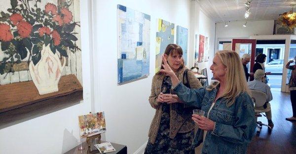 Clients talking about the work at a reception for the Patti Davis Ganek show.