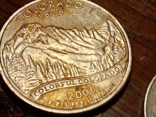 A 2006  d Colorado quarter, double die obverse and reverse. The reverse bottom left as a 1 in front on the 2006. 12006