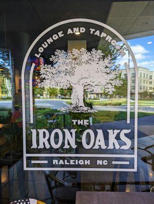 Outside. The Iron Oaks storefront logo. Located at Glenwood Place. Free deck parking on-site.