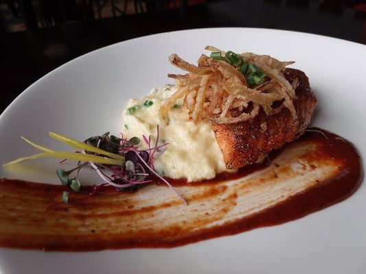 Cajun seared salmon with scallion grits , crispy onion and house-made BBQ sauce