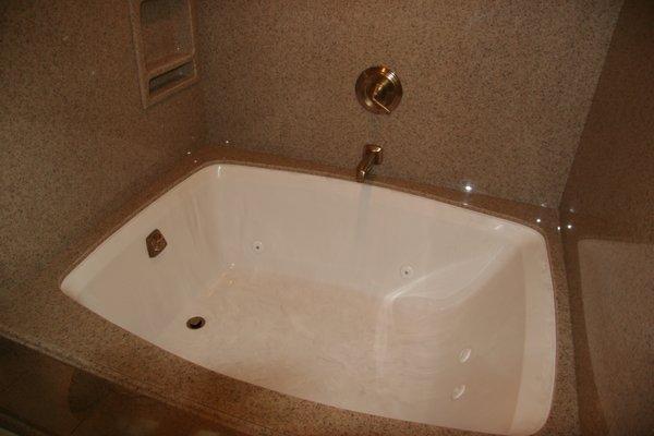 Tub Decks are used to enlarge a tub area. Composite Marble Tub with Engineered Granite Deck and Walls