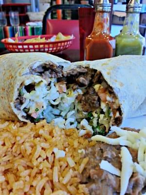 This is a steak burrito with everything plus onion and cilantro.