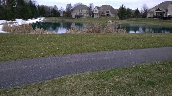 paved walking trail loops around the park and pond