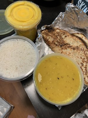 Mango lassi top left - came wrapped in seran wrap to prevent spillage in takeout bag. Pista coconut naan and dal tadka on right