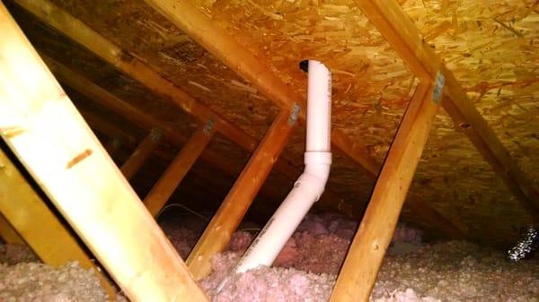 Attic prior to Mooney & Moses install. Note height of insulation and pink color.