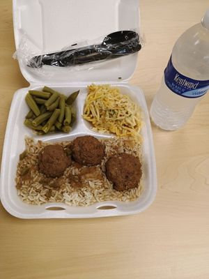 Smothered meatballs over rice, green beans and baked spaghetti. Water purchased separately.