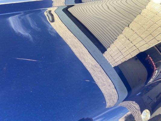 Cracks in the paint on the trunk lid.